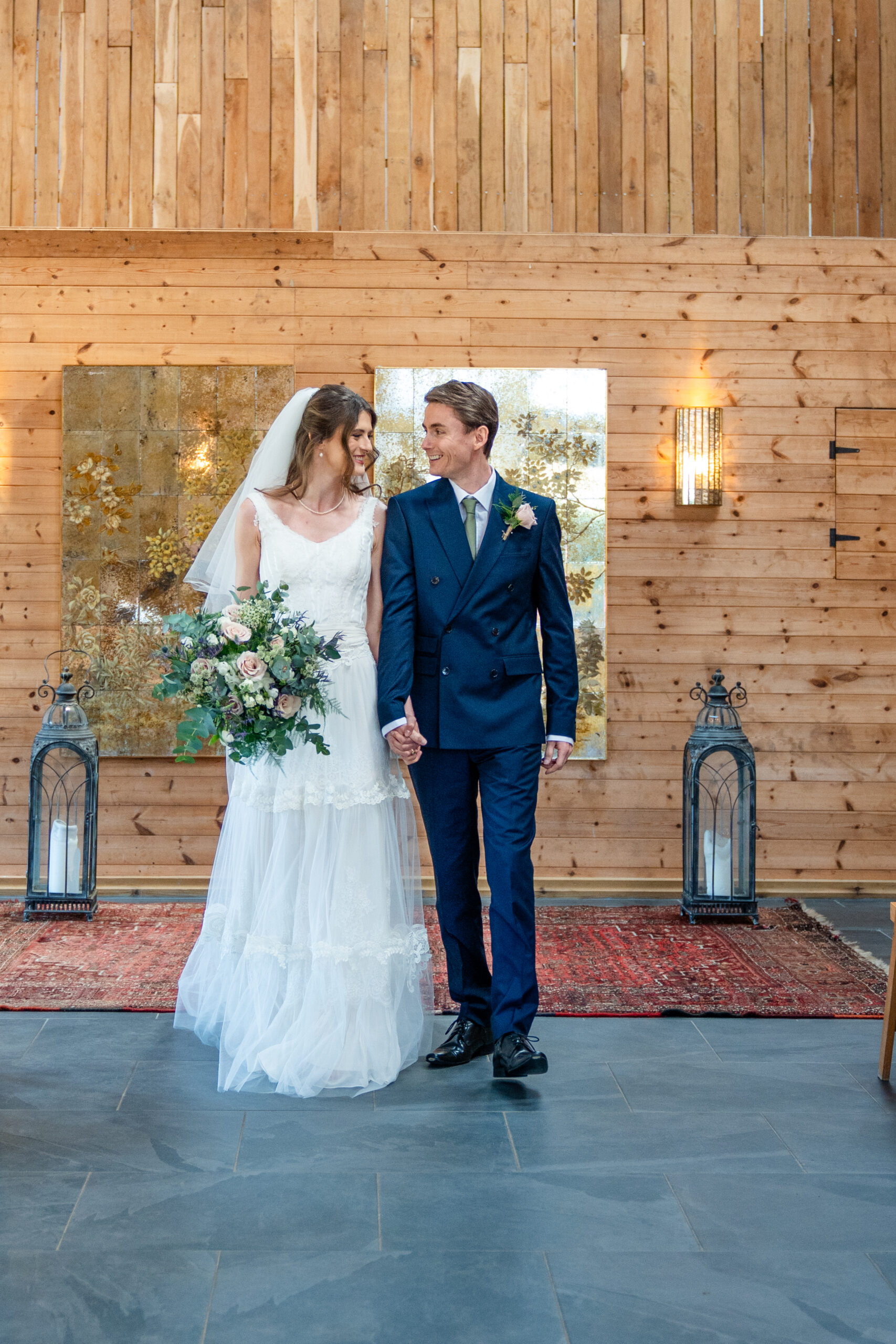 Bride and groom in the barn after their ceremony captured by Chafford Park wedding photographer 