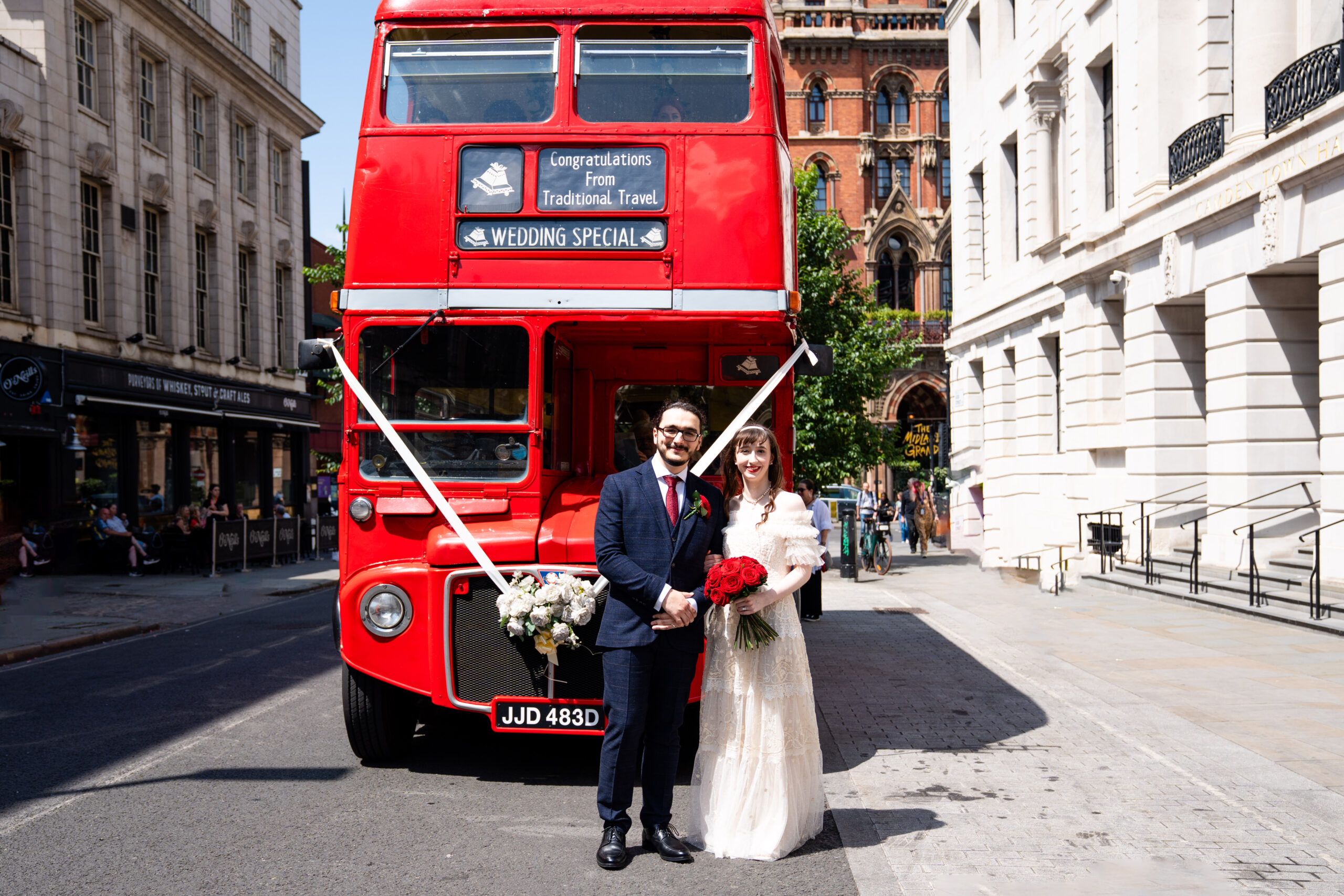 Bride and Groom in front of red bus and Camden Town Hall