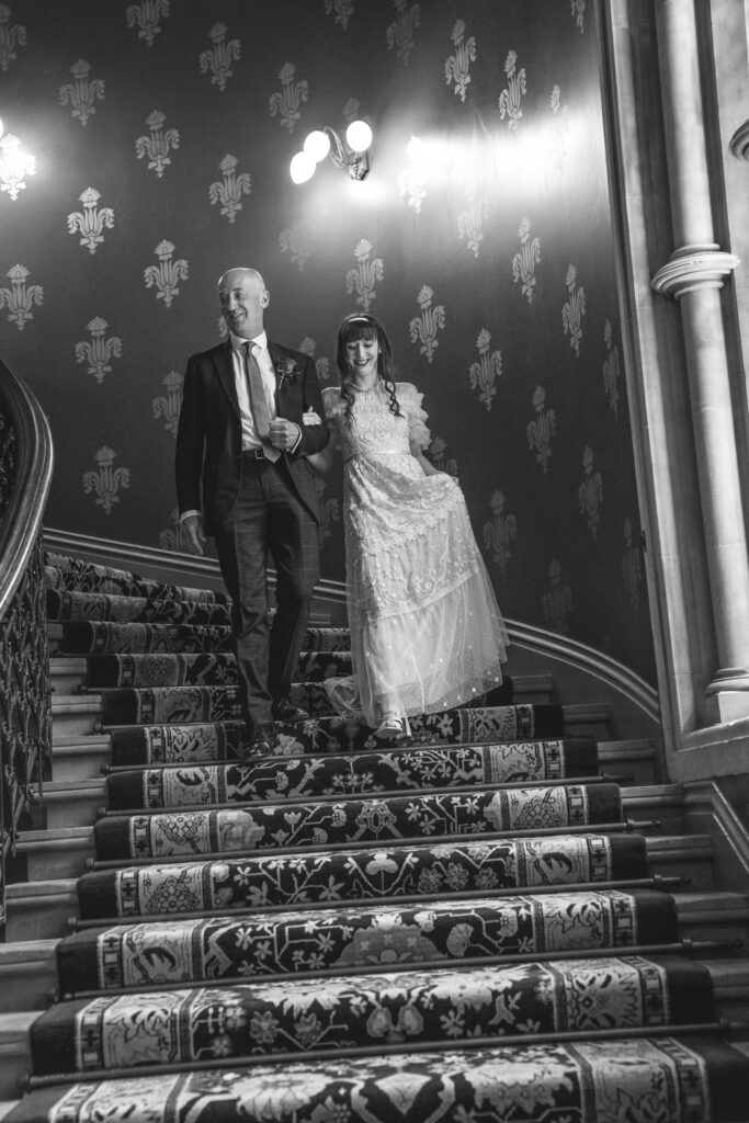 Bride and father walking down the stairs hotel renaissance London 