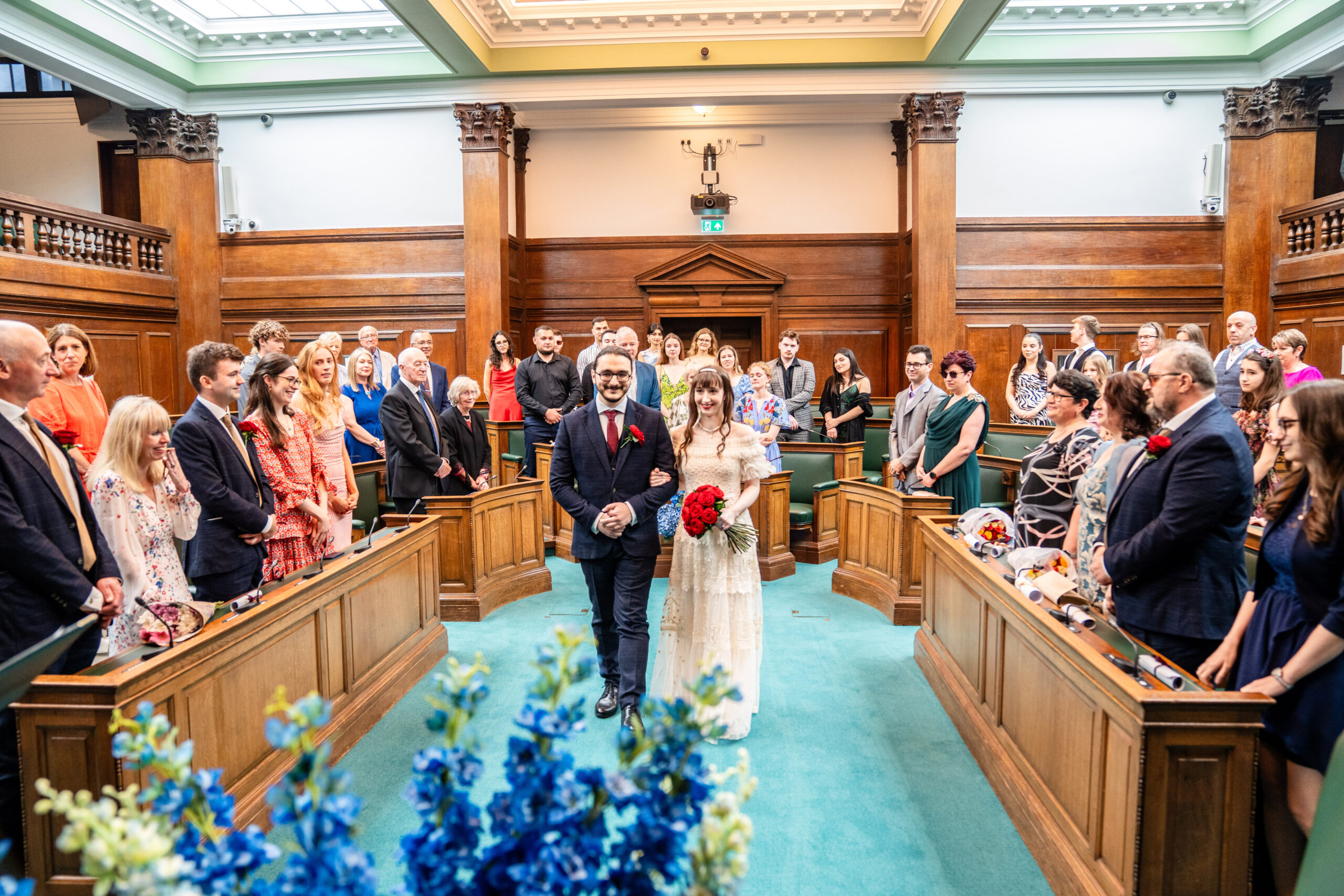 Bride and groom walking down the isle in Camden Town Hall