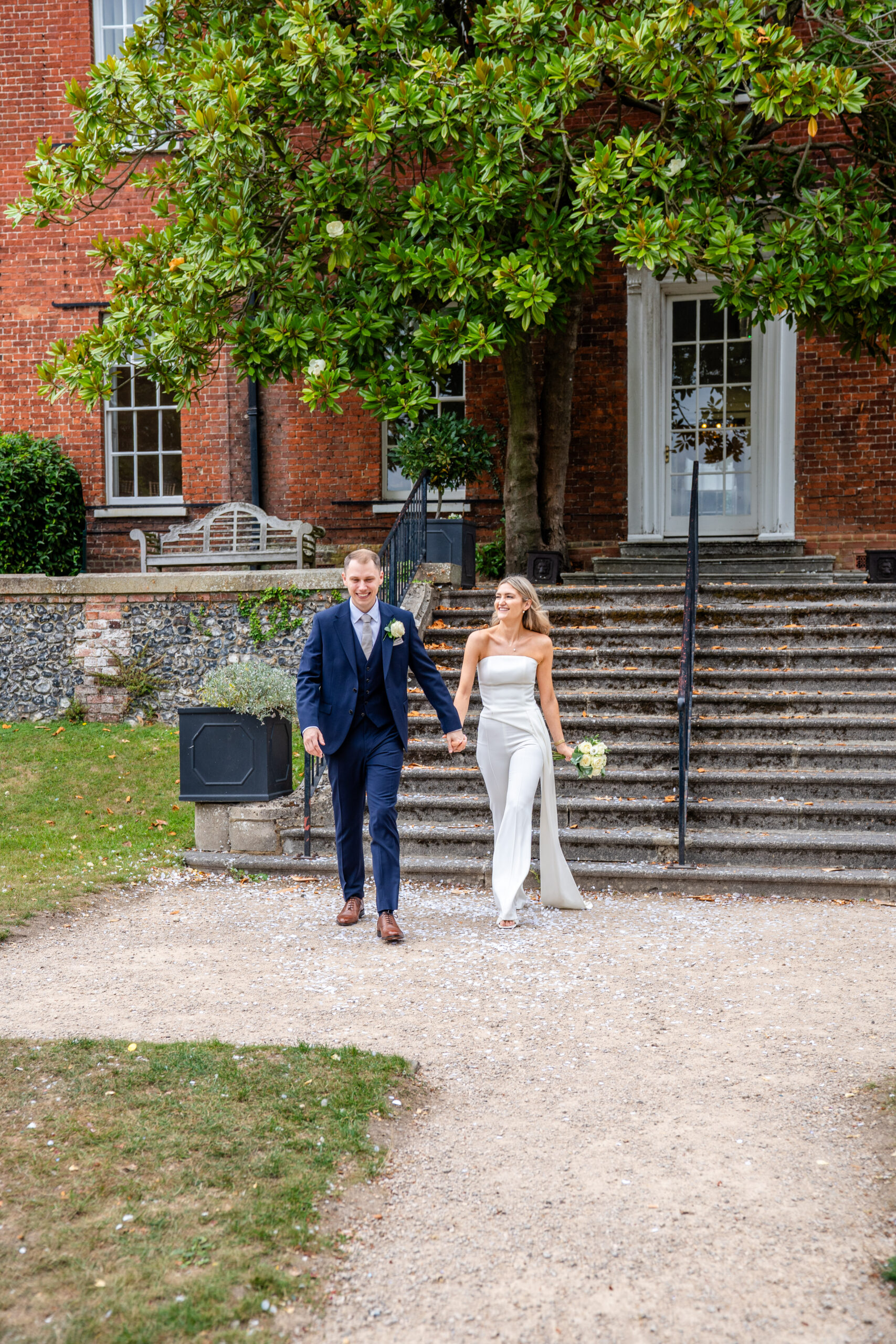 Couple walking hand in hand in the gardens