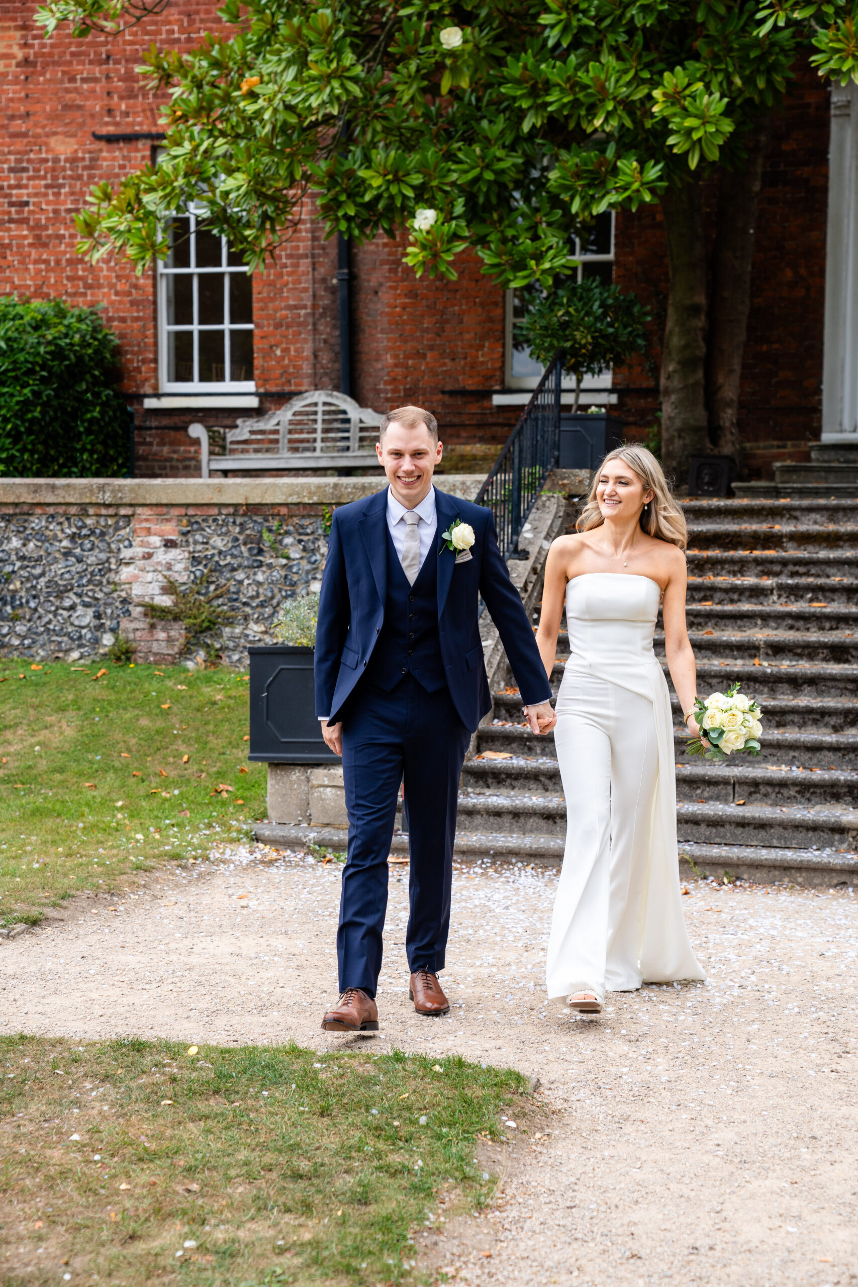Candid documentary Surrey wedding photographer capturing bride and groom walking