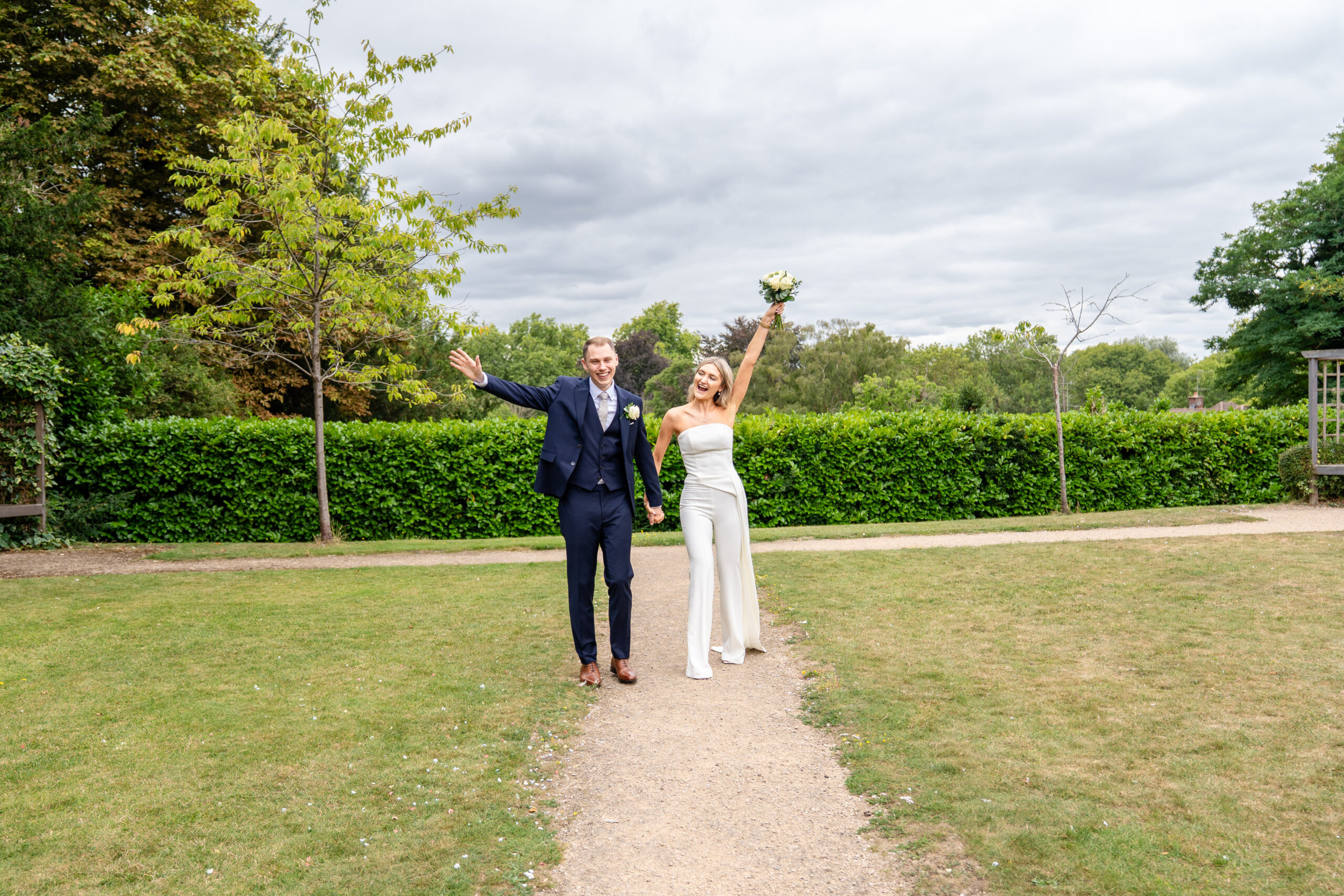 Fun couple portrait in the gardens of Leatherhead registry office