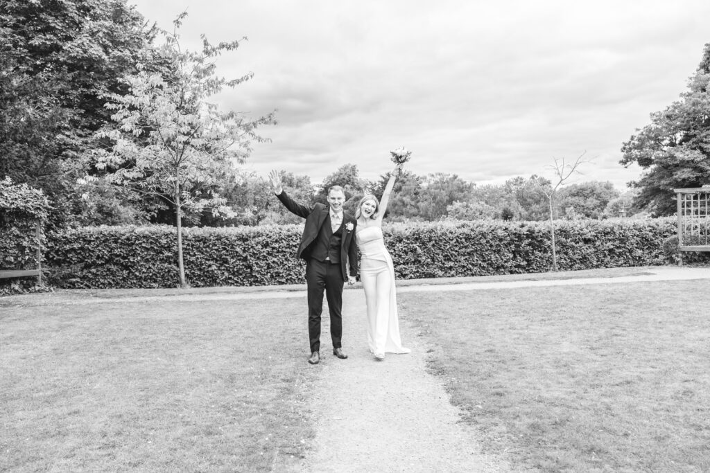 Black and white photo of couple portraits in the gardens of Leatherhead registry office
