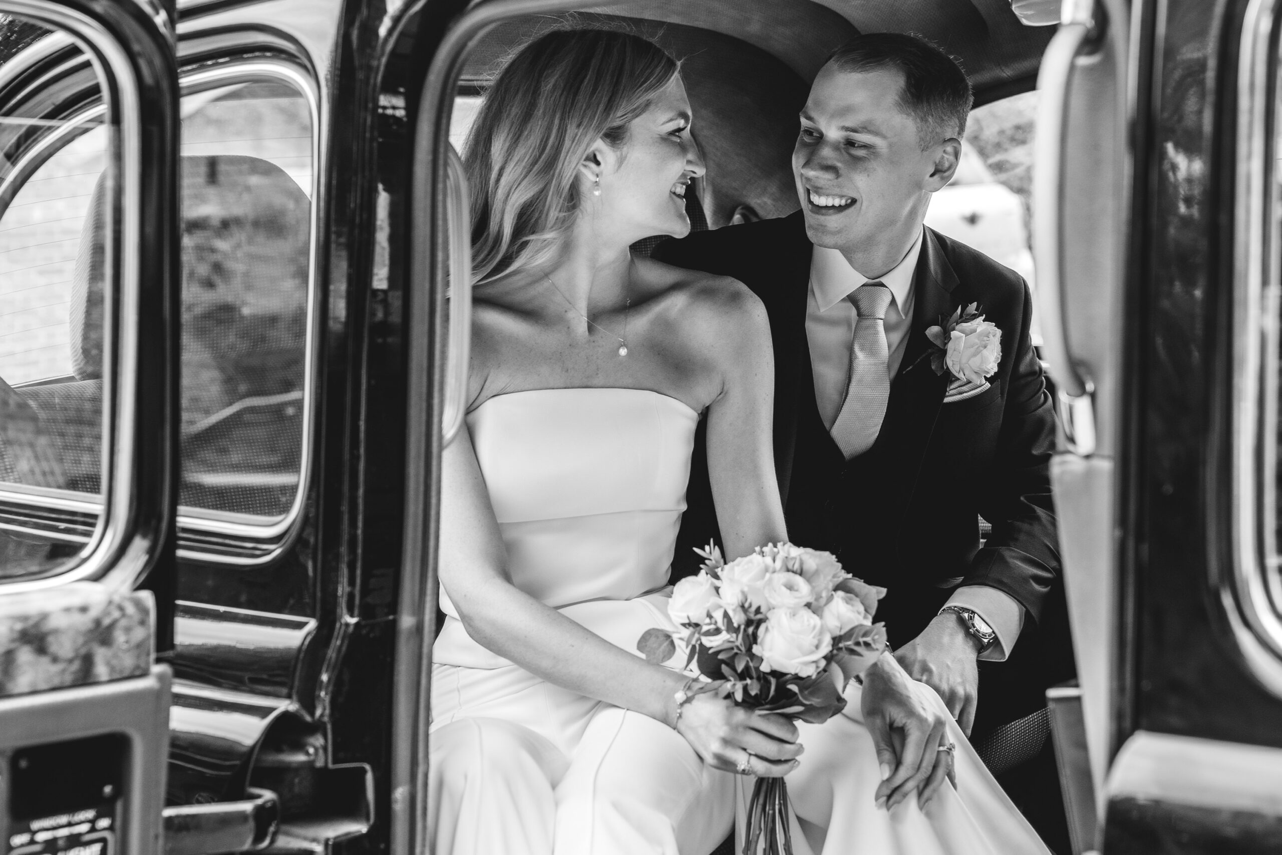 black and white taxi classic couple portrait,Surrey registry office wedding photography