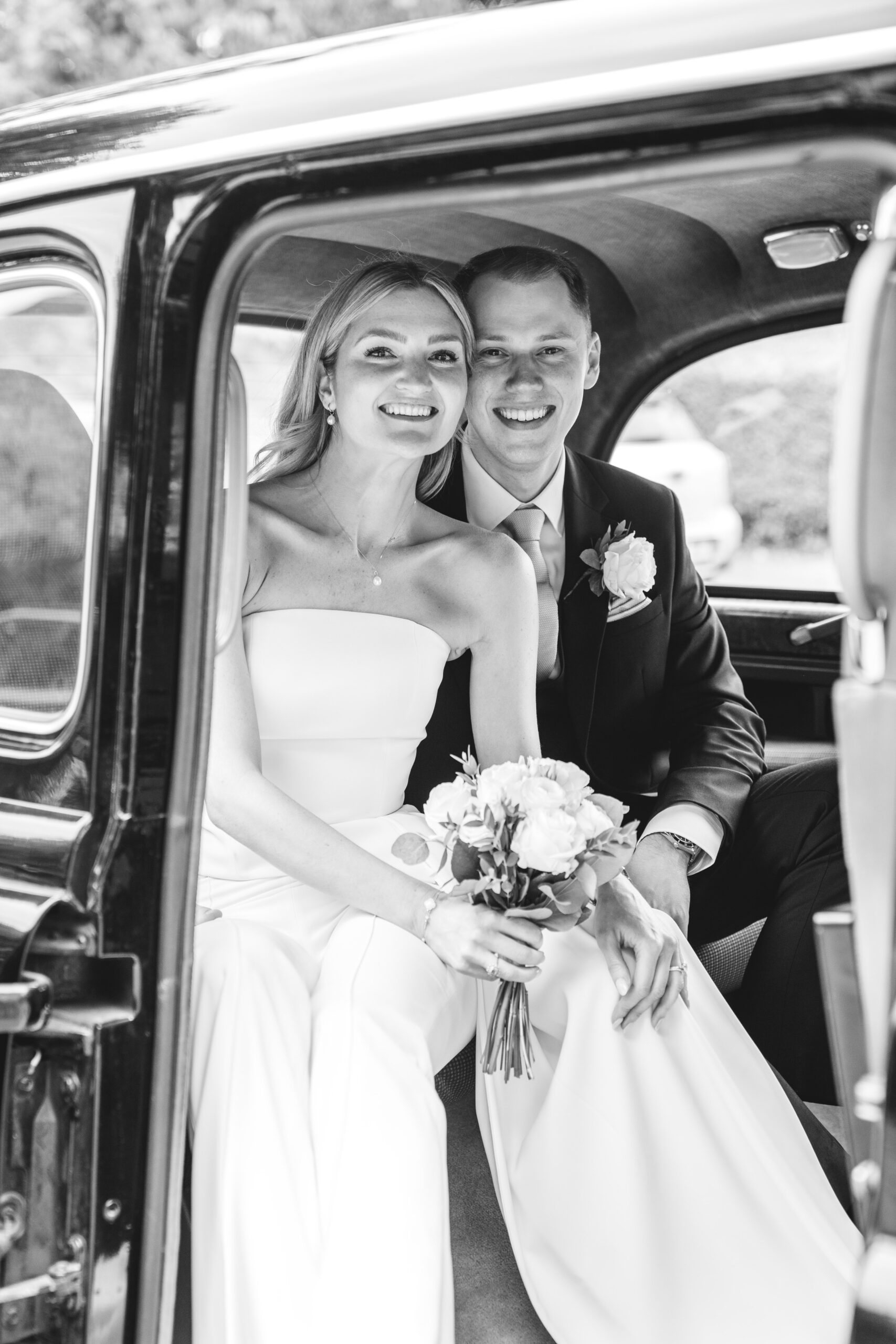 Relaxed portraits leaving in a taxi for the reception photographed by Surrey wedding photographer