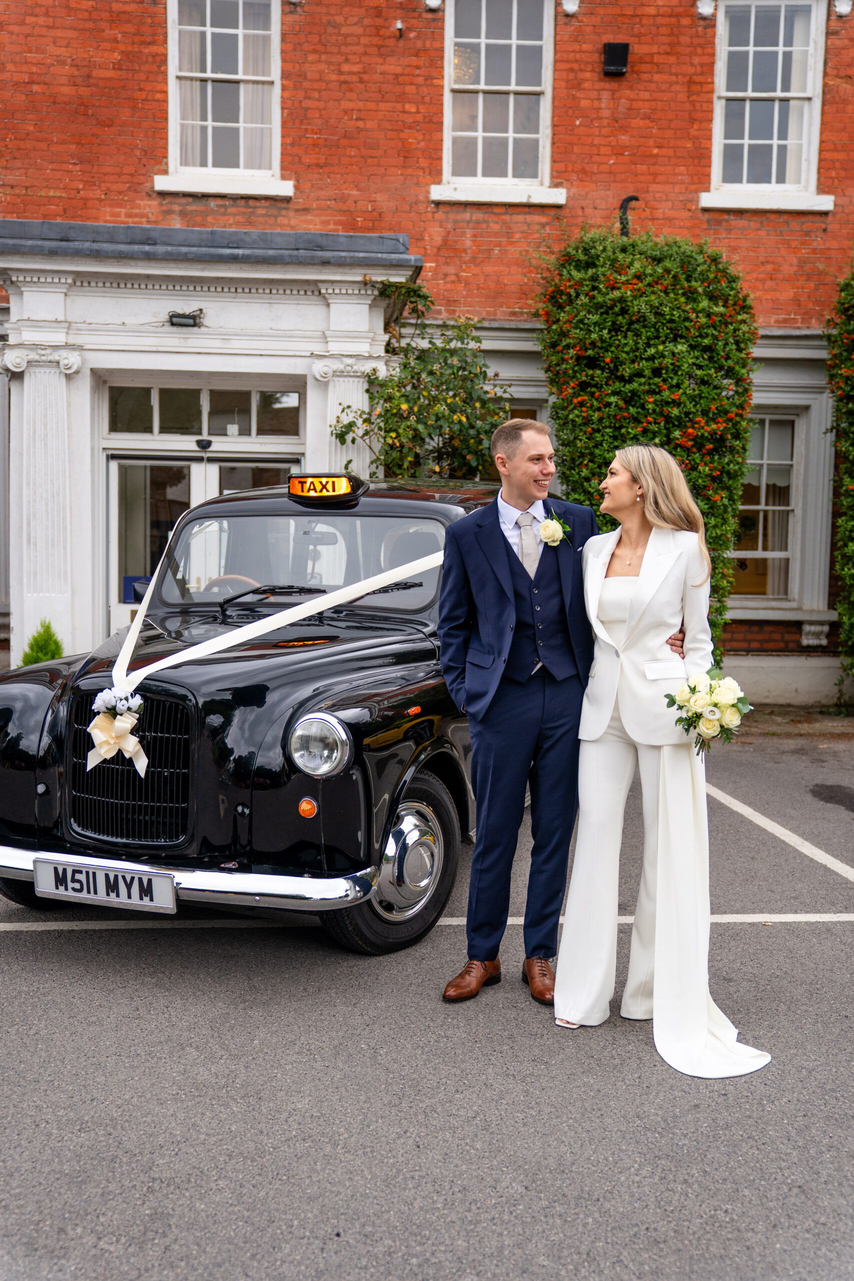 Bride arriving at Leatherhead Register Office entrance, with taxi