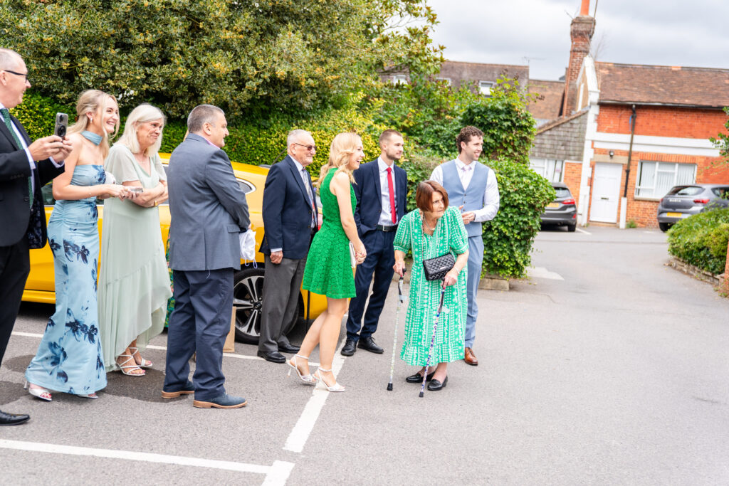guests reactions of Bride and groom arriving at Leatherhead Register Office entrance