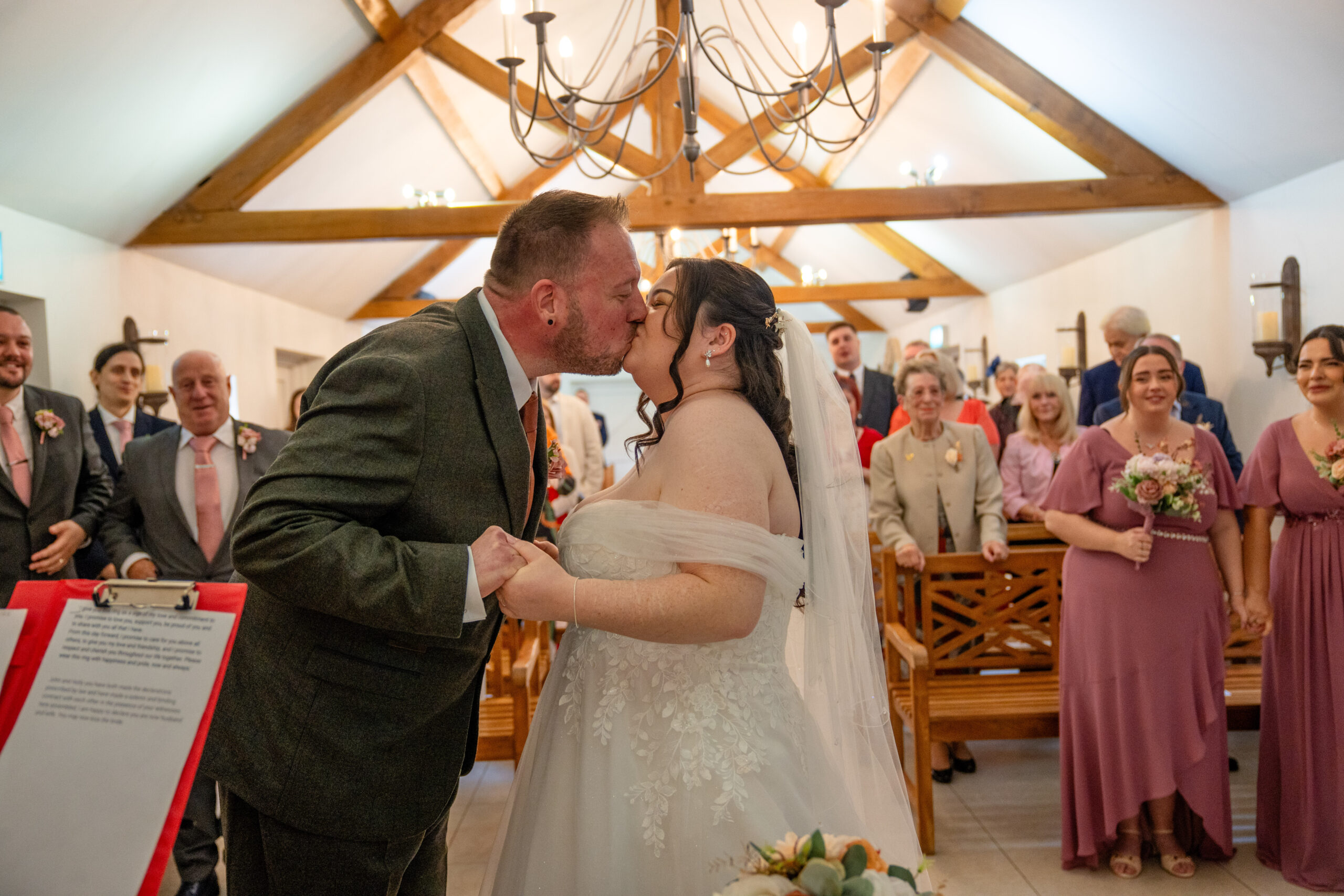 Couple exchanging vows and first kiss in the Oaks Farm orangery — Oaks Farm wedding photographer