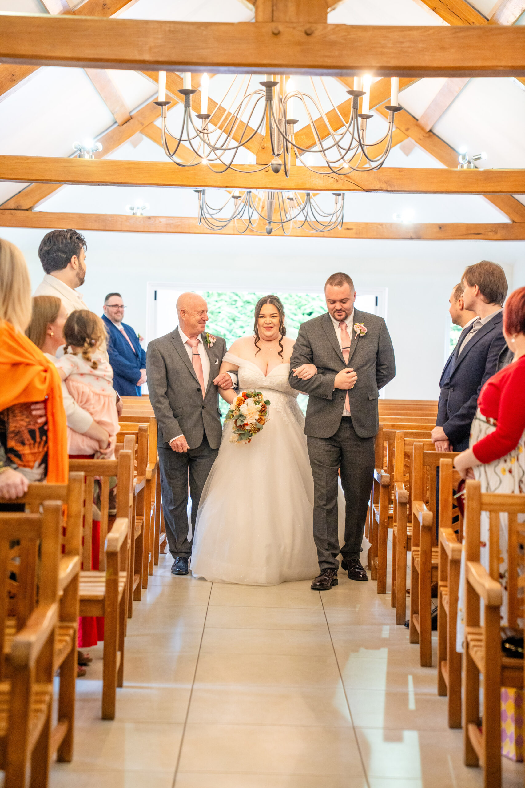 Walking down the aisle Wedding ceremony in the Oaks Farm orangery bathed in natural autumn light