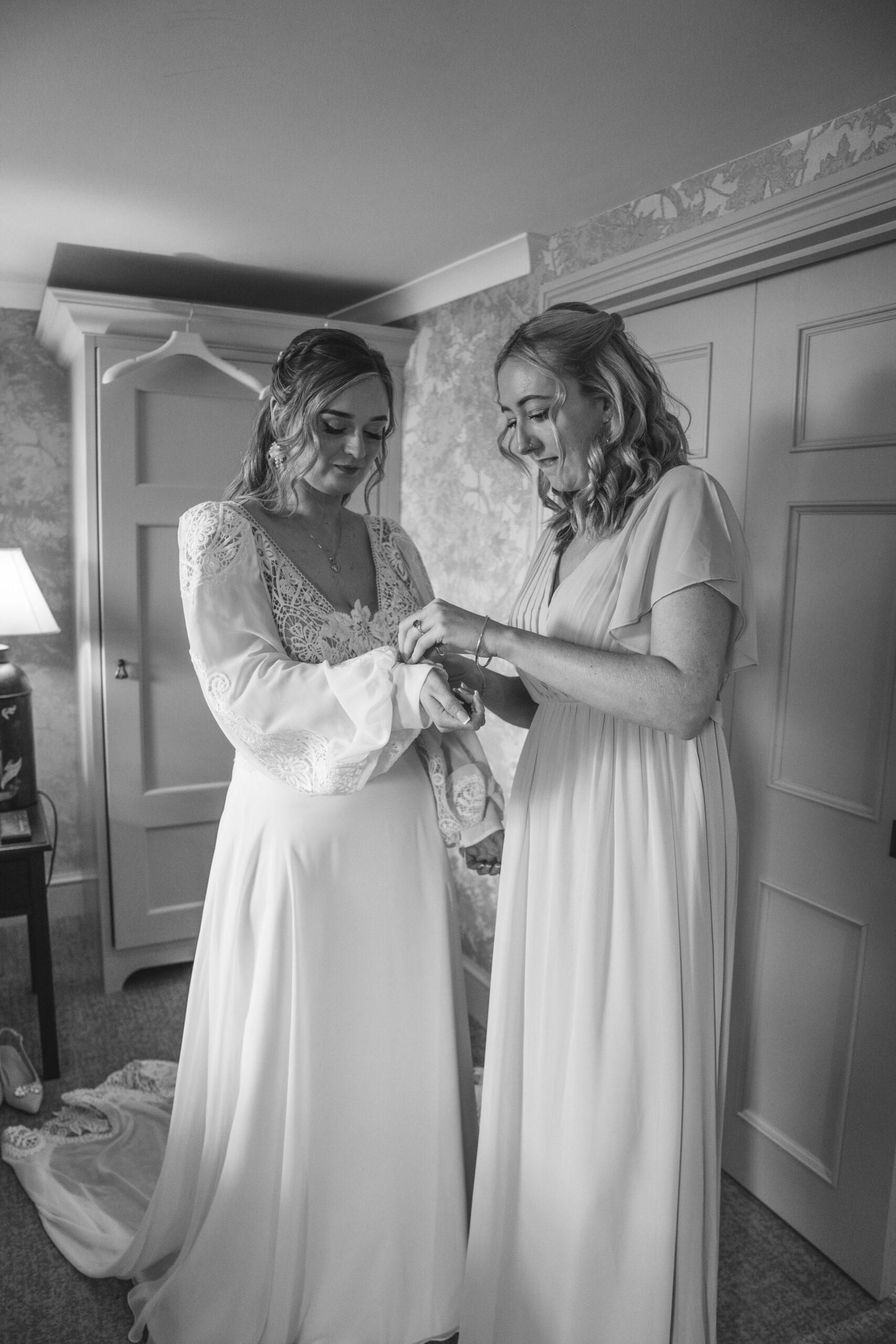 Black and white documentary photography of a bride getting ready at Richmond Hill Hotel suite.