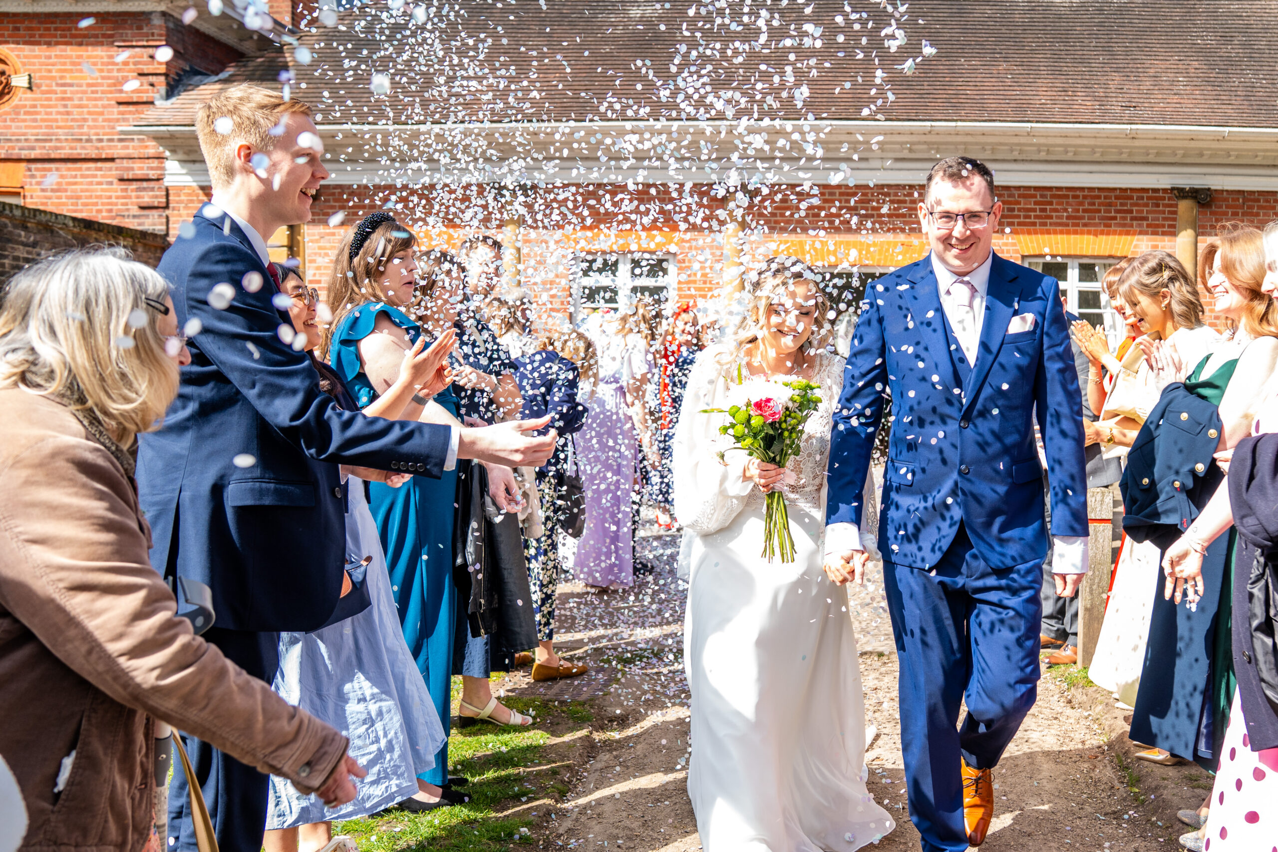 Joyful confetti moment on the stone steps at a York House wedding London.