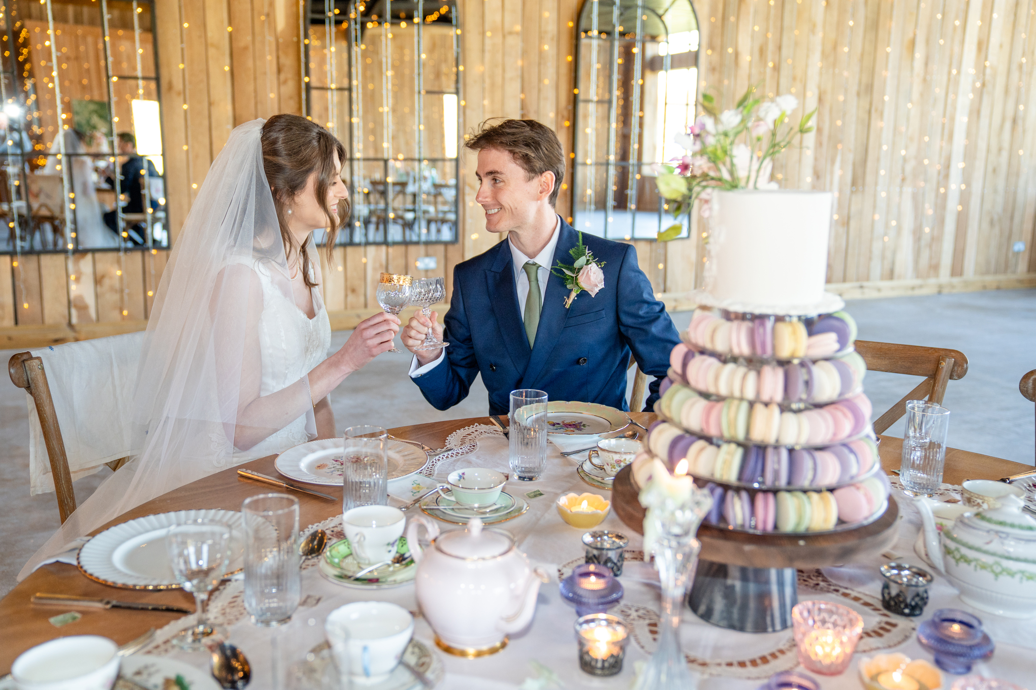 Candid wedding photography of a newlywed couple outside the historic rustic barn at Chafford Park Estate, captured by a Kent wedding photographer.