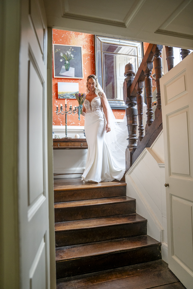 Bride walking down the stairs from bridal prep