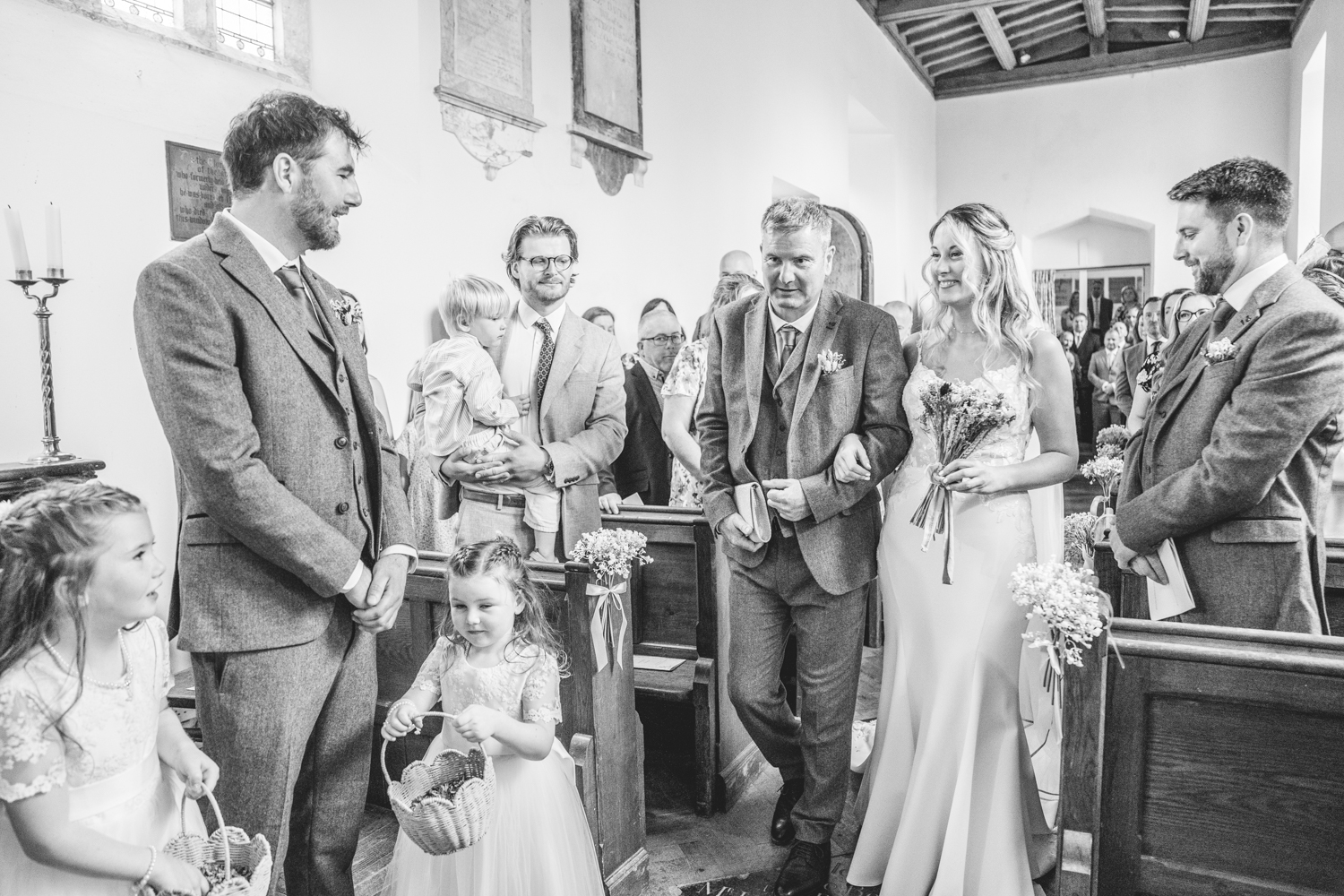 Bride walking down the aisle to meet groom