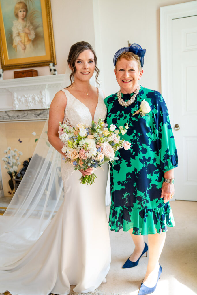 Candid moment of mother of the bride celebrating during morning preparations at a luxury manor house.